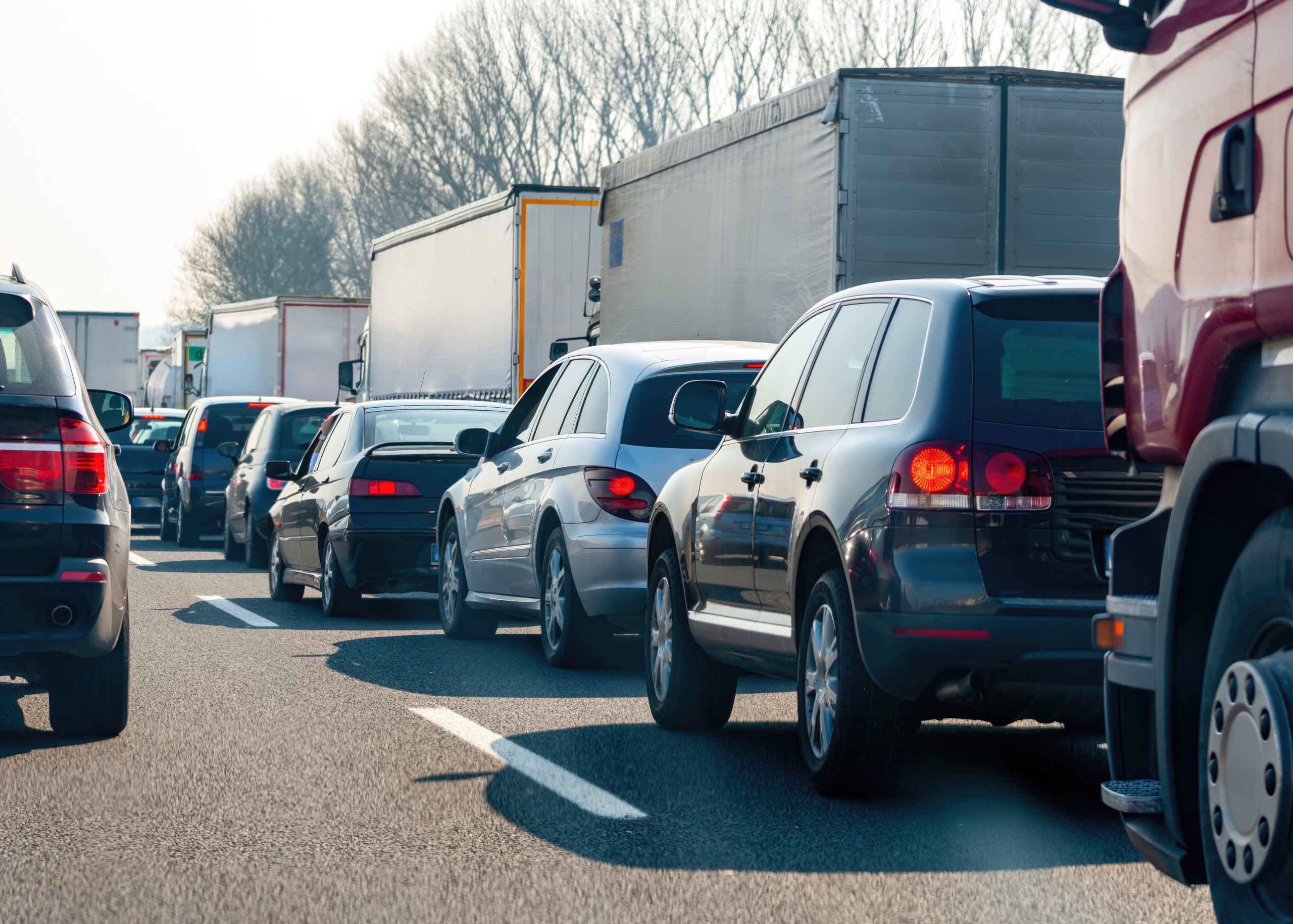 Traffic jam on highway with cars and trucks stuck in congestion